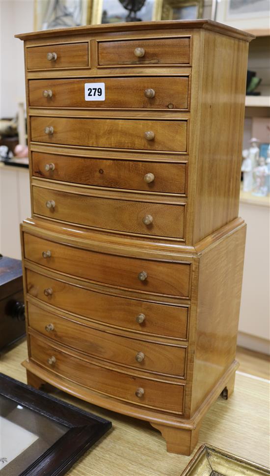 A miniature bow fronted chest on chest